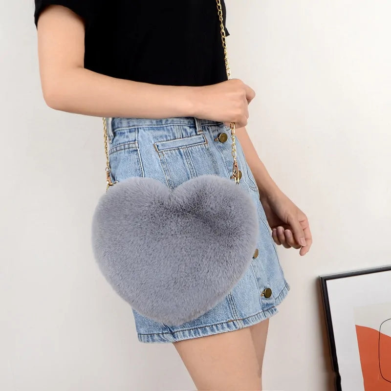 Heart Shaped Faux Fur Crossbody Wallet Crafted from high-quality faux fur, this wallet is soft to the touch and luxurious to look at.